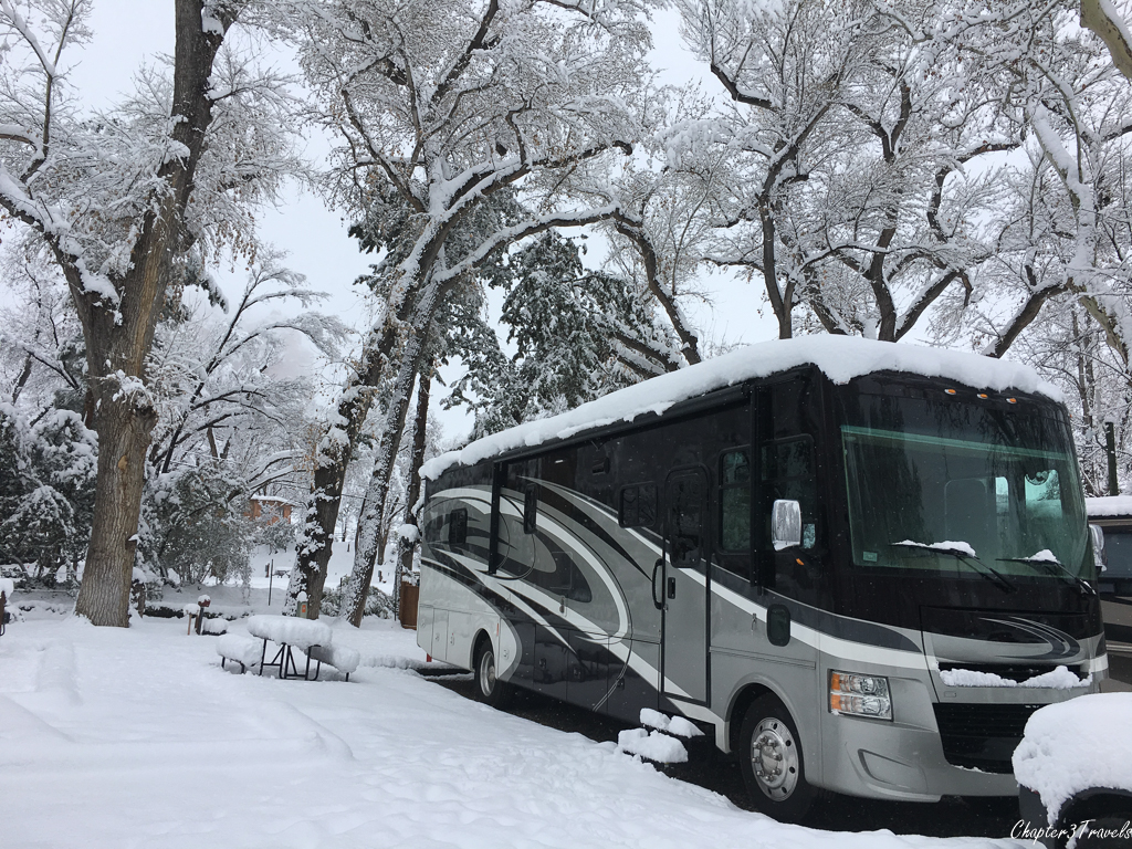 Snow covered RV and picnic table